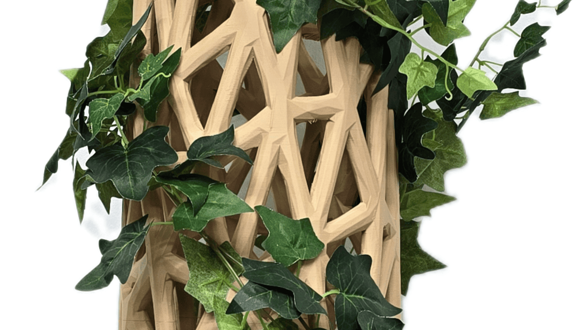 A wooden lattice structure with geometric cutouts, intertwined with green artificial ivy leaves. The background is white, emphasizing the contrast between the wood and the foliage.