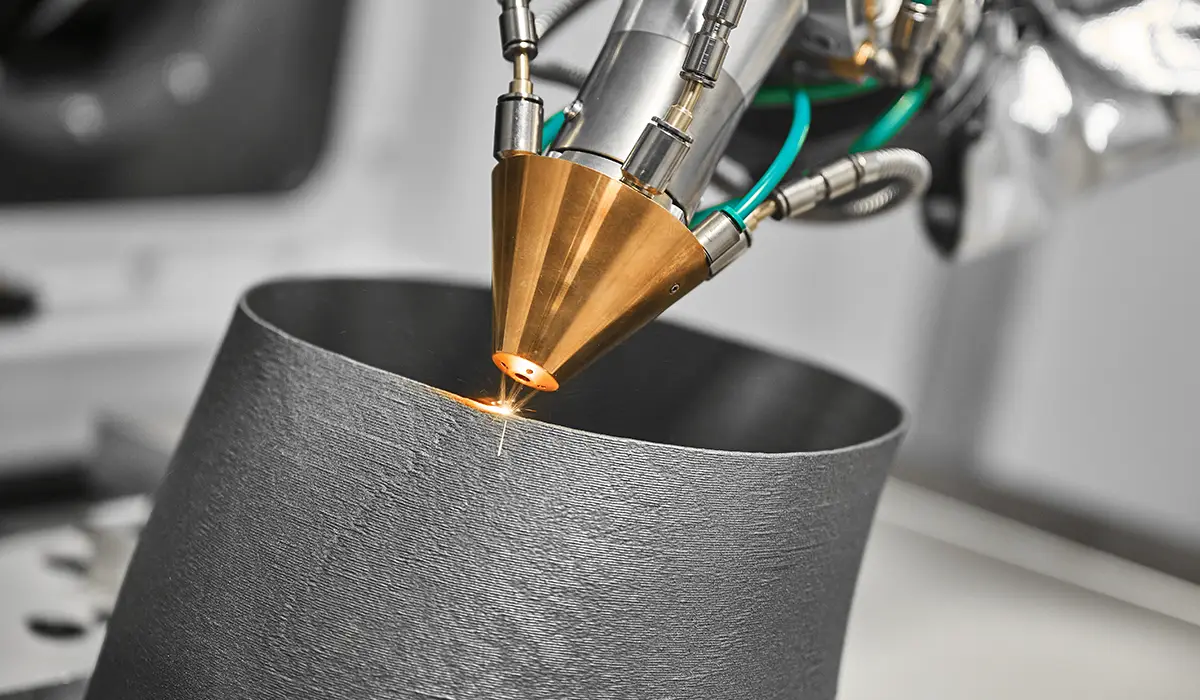 An industrial metal 3D printer uses a laser to apply precise metal layers to produce a complex component using the additive manufacturing process.